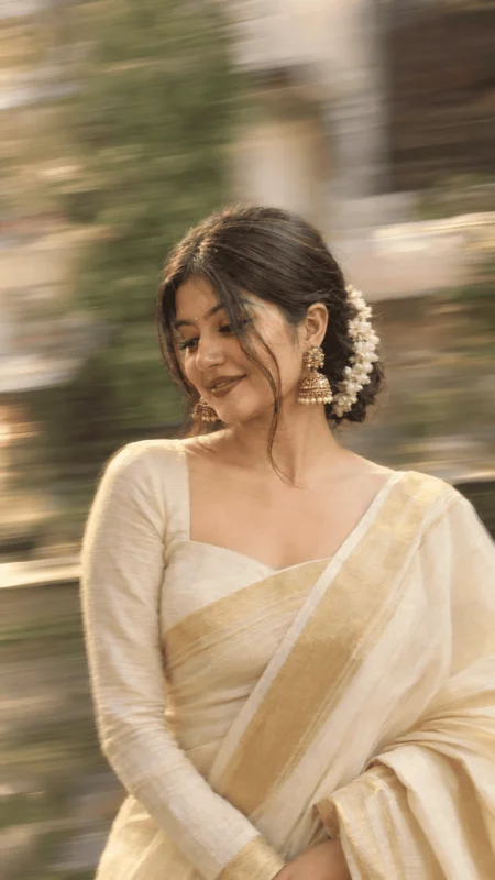 Woman in cream white saree with jasmine gajra vintage cinematic portrait