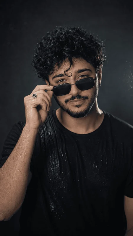 Ultra realistic male portrait with wet curly hair black sunglasses and dramatic lighting