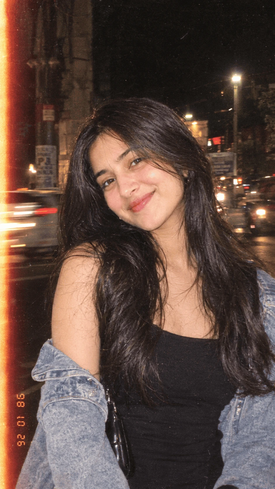 Vintage night street girl portrait with denim jacket and city lights