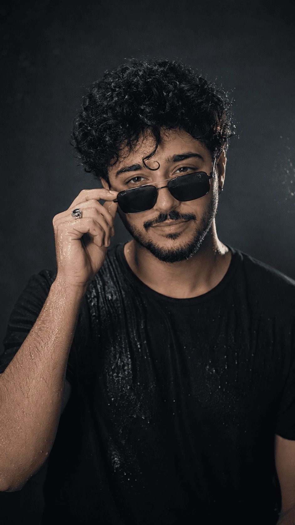 Ultra realistic male portrait with wet curly hair black sunglasses and dramatic lighting